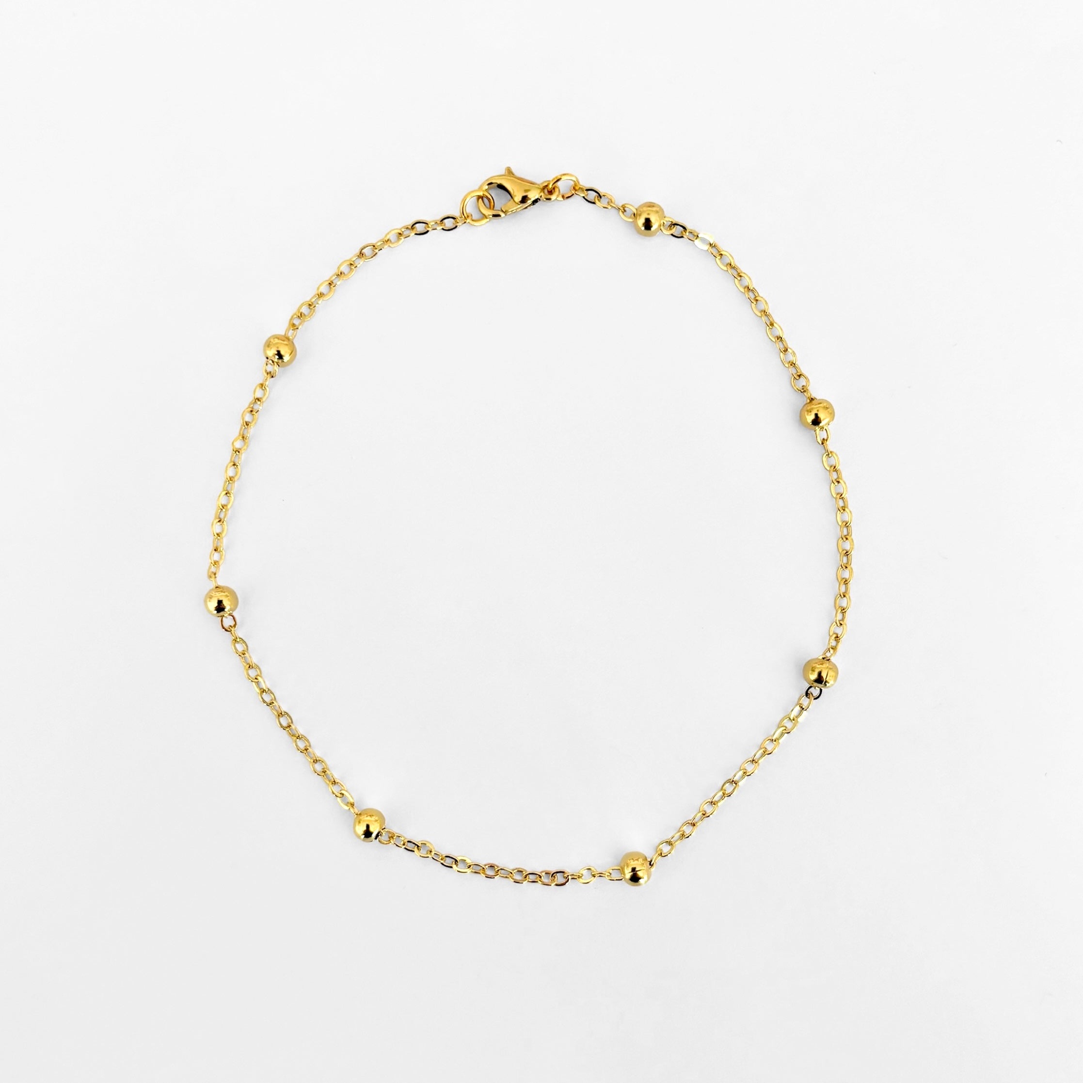 Tobillera bolitas doradas